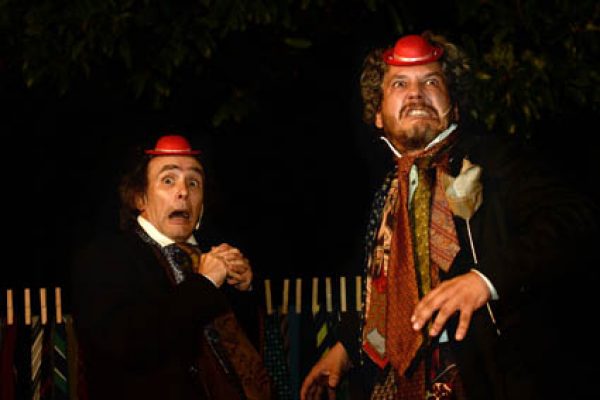 I due attori in scena con un piccolo cappello rosso sulla testa